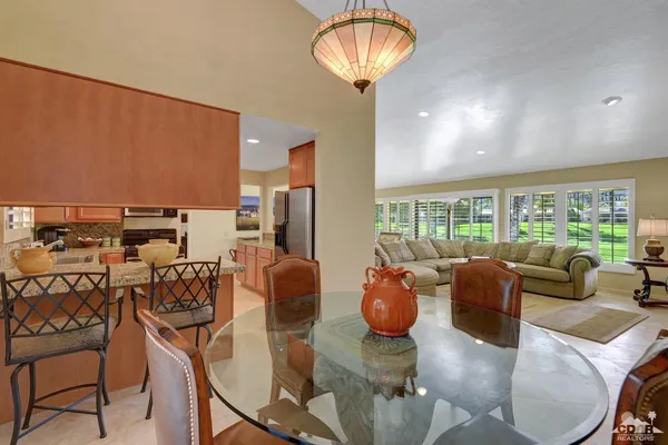 a living room with furniture a chandelier and a large window