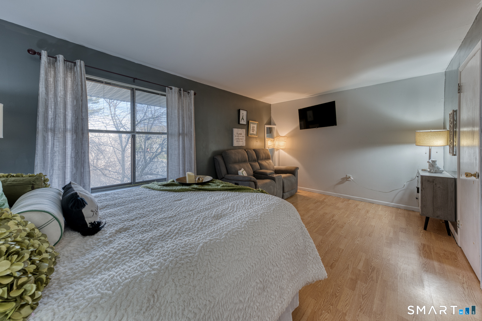 17 Hemlock Court, Unit 17 Cromwell, CT 06416 - Photo 25 of 36 a spacious bedroom with a bed and wooden floor