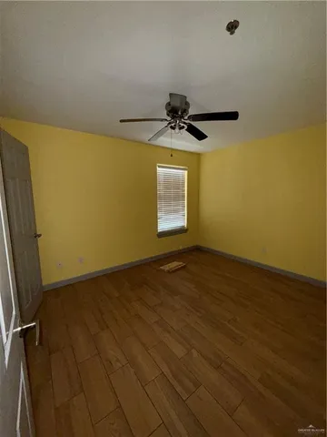 a view of a room with wooden floor and staircase