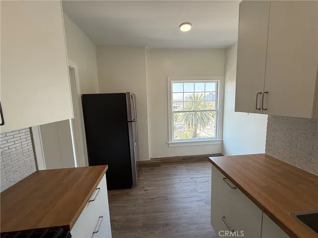 a kitchen with stainless steel appliances granite countertop a refrigerator and a stove