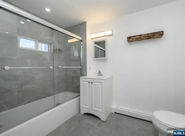 a bathroom with a sink a toilet and bathtub