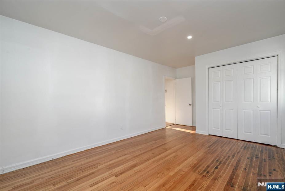 49 River Street, Unit 2 Lodi, NJ 07644 - Photo 20 of 24 a view of an empty room with wooden floor