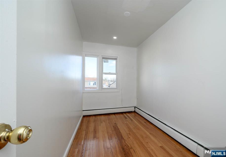 49 River Street, Unit 2 Lodi, NJ 07644 - Photo 21 of 24 a view of room with window and wooden floor