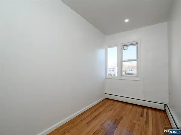 a view of a room with wooden floor and window