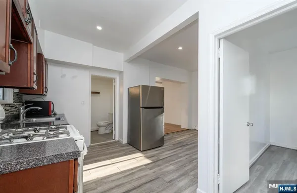 a kitchen with granite countertop cabinets and steel stainless steel appliances