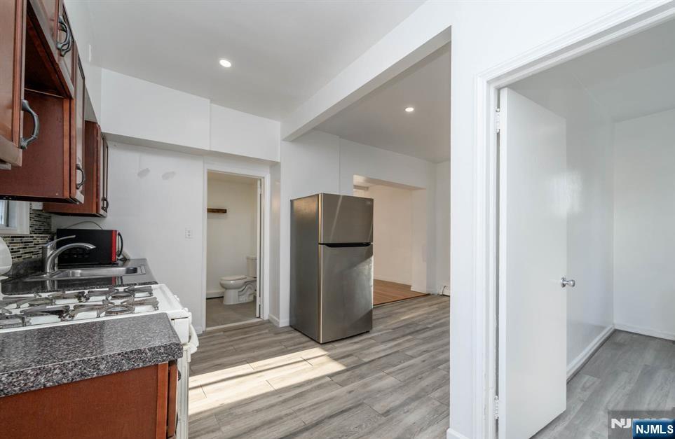 49 River Street, Unit 2 Lodi, NJ 07644 - Photo 3 of 24 a kitchen with granite countertop cabinets and steel stainless steel appliances