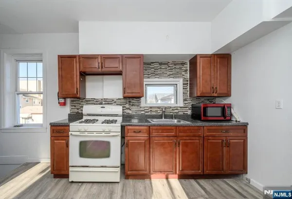 a kitchen with a stove top oven sink and cabinets