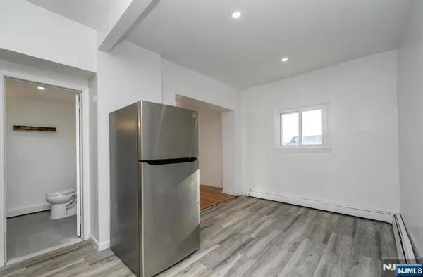a room with wooden floor and a toilet