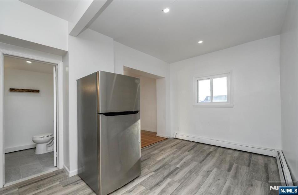 49 River Street, Unit 2 Lodi, NJ 07644 - Photo 6 of 24 a room with wooden floor and a toilet