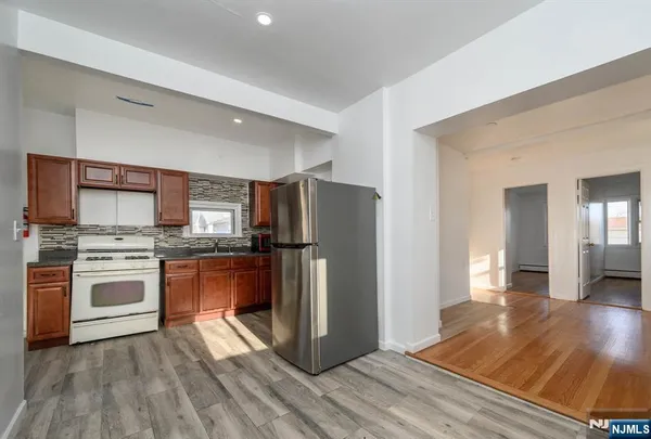 a kitchen with stainless steel appliances a refrigerator stove and sink