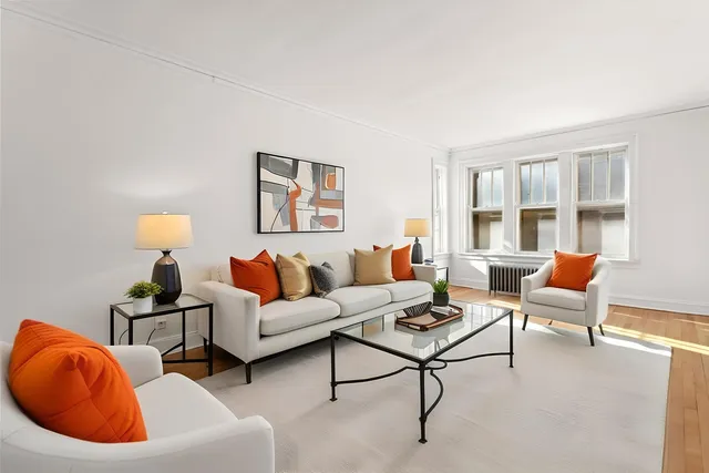 a living room with furniture and a lamp