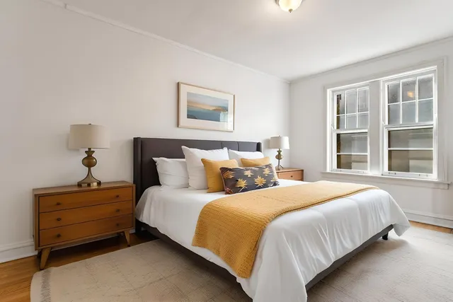 a bedroom with bed and window