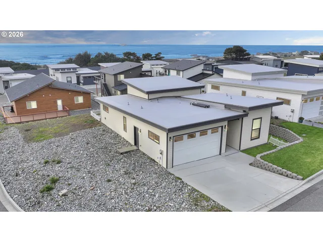 an aerial view of a house with a yard and furniture