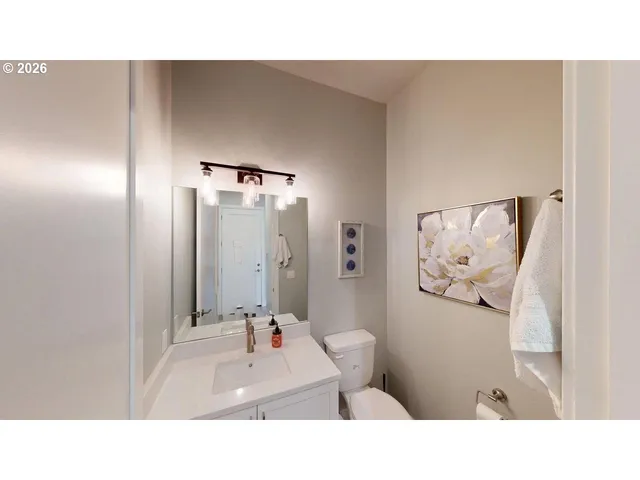 a living room with a bed and a wall painting