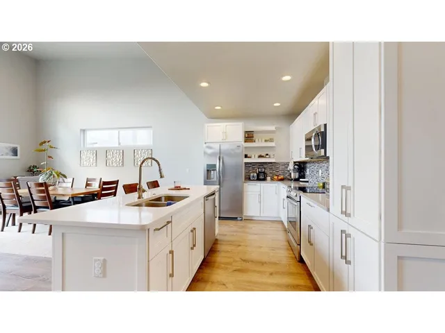 a open kitchen with stainless steel appliances kitchen island a sink dishwasher a oven with white cabinets