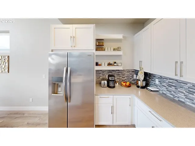 a kitchen with kitchen island a refrigerator sink and stove