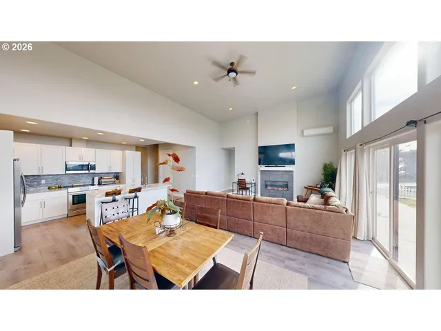 a living room with kitchen island furniture and a flat screen tv