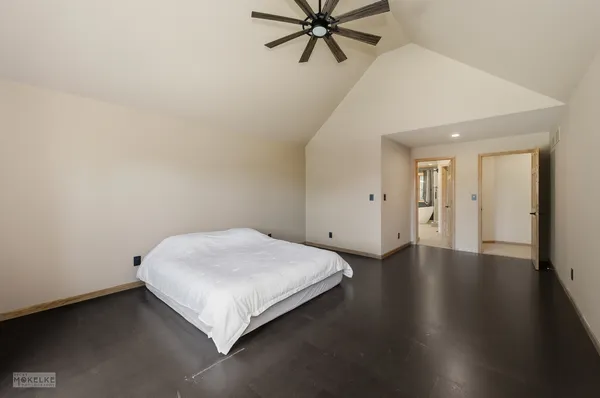 a bedroom with a bed and a painting on the wall