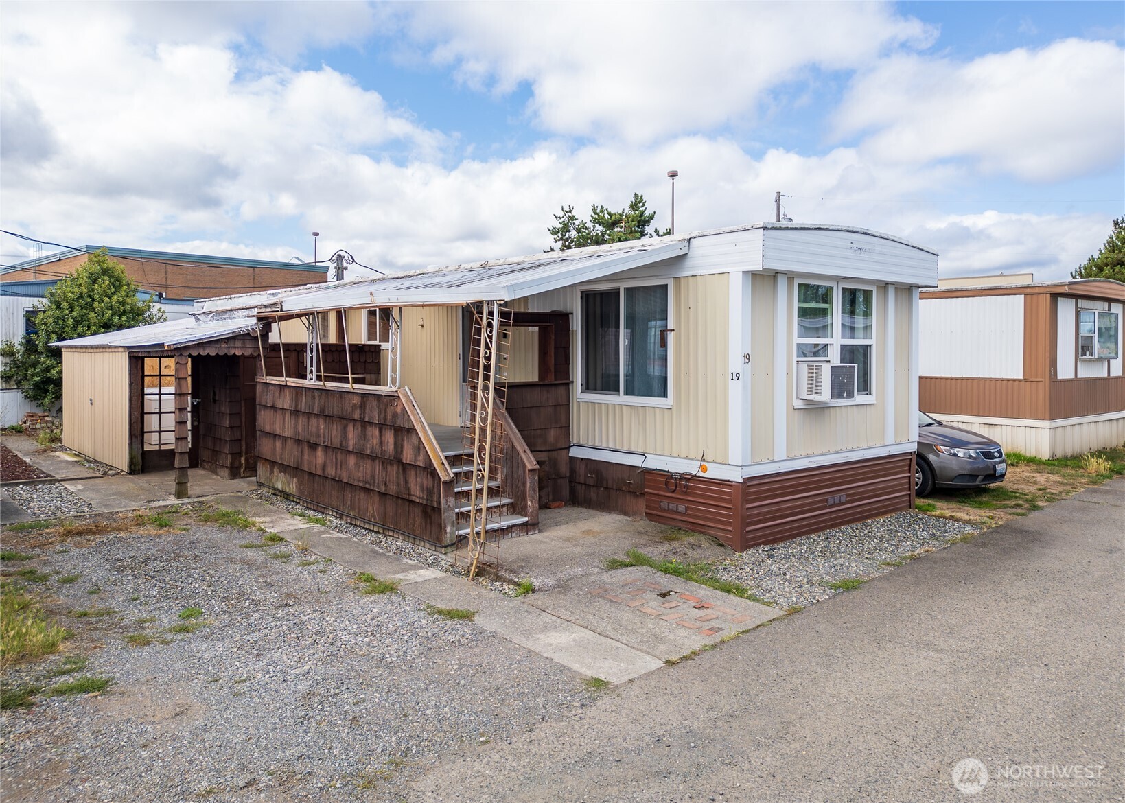 a view of a house with a yard and wooden fence