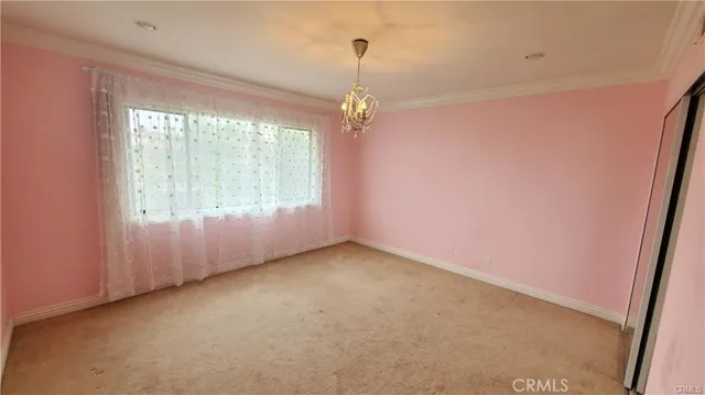 an empty room with windows and entrance