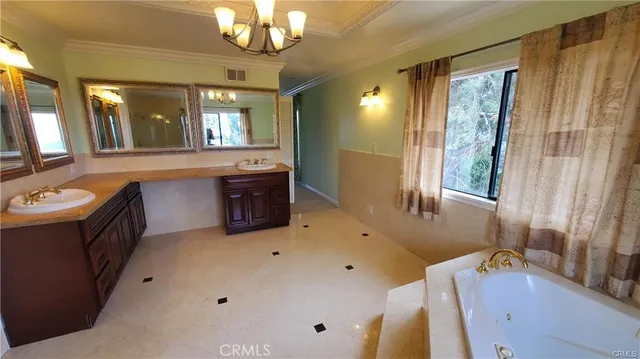 a bathroom with a tub sink and mirror