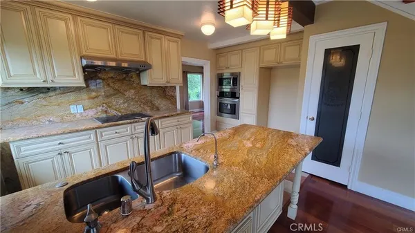 a kitchen with stainless steel appliances granite countertop a sink and cabinets