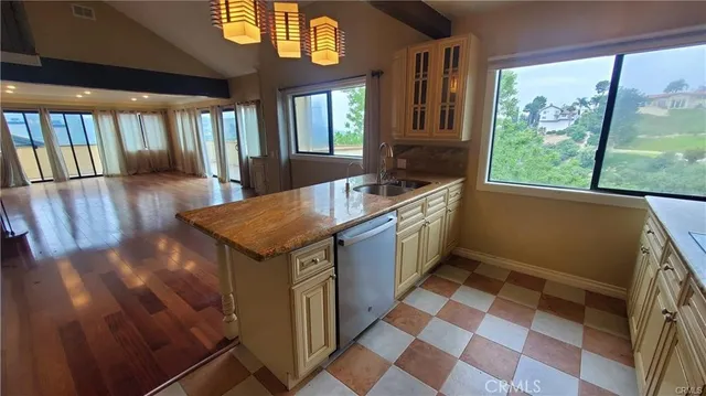a kitchen with a sink a stove and a window
