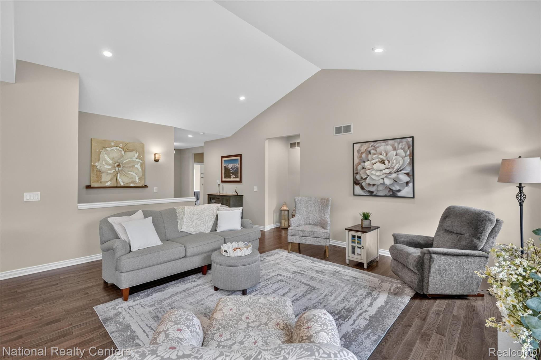 740 North Mill Street South Lyon, MI 48178 - Photo 14 of 56 Vaulted ceiling living area featuring rich wood-finish flooring, recessed lighting, and neutral wall tones