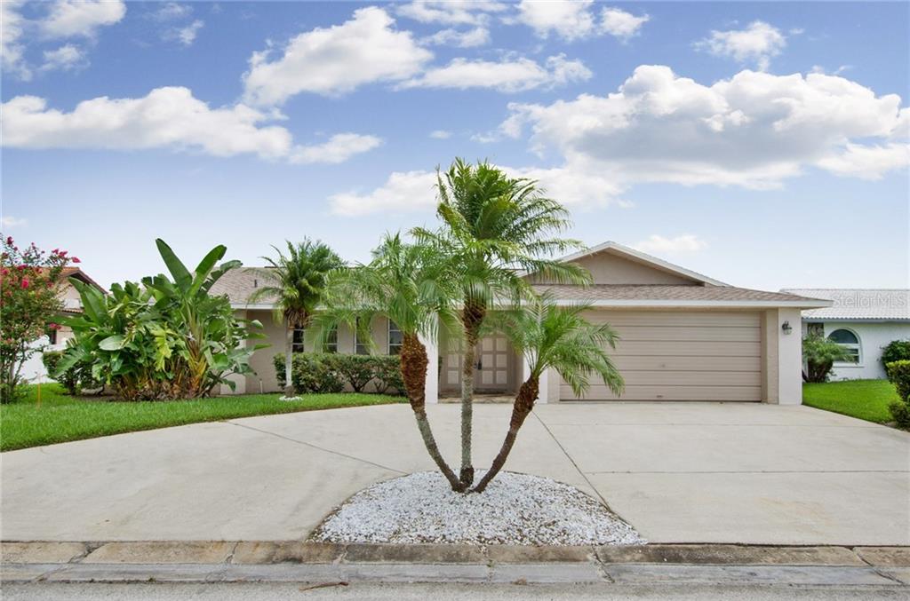 ESTABLISHED TROPICAL LANDSCAPING, CIRCULER DRIVE WITH 2 CAR GARAGE OFFERING A TON OF OFF STREET PARKING