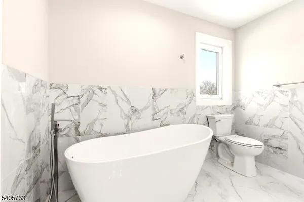 a white bath tub sitting next to a white toilet
