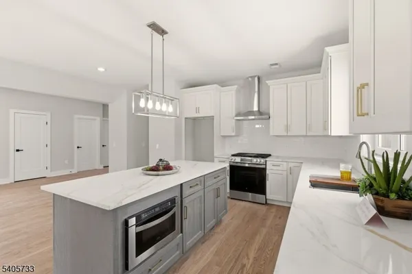 a kitchen with a stove sink and cabinets