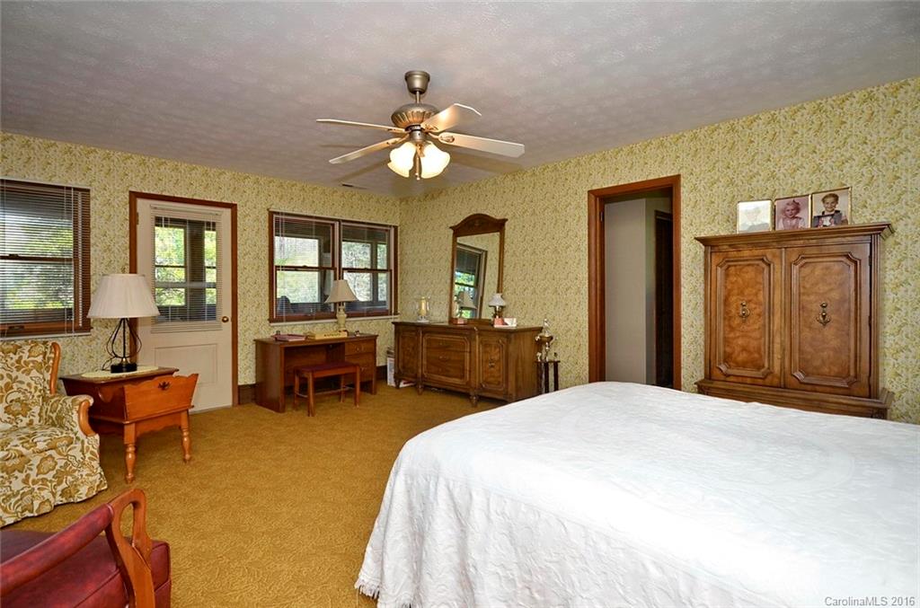 110-114 Hilltop Road Waynesville, NC 28786 - Photo 11 of 21 a bedroom with a bed and furniture