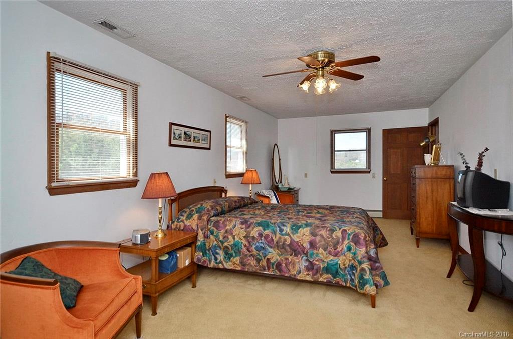 110-114 Hilltop Road Waynesville, NC 28786 - Photo 15 of 21 a bedroom with bed and a window