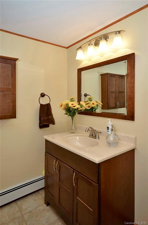 110-114 Hilltop Road Waynesville, NC 28786 - Photo 18 of 21 a bathroom with a sink and a mirror