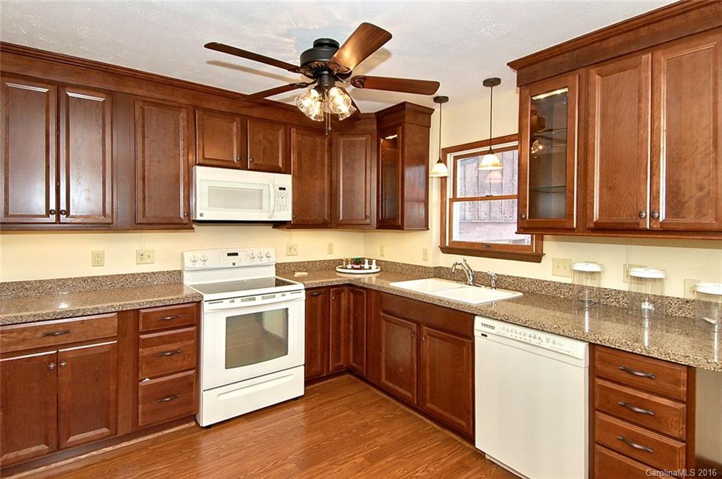 110-114 Hilltop Road Waynesville, NC 28786 - Photo 7 of 21 a kitchen with a sink cabinets appliances and a window