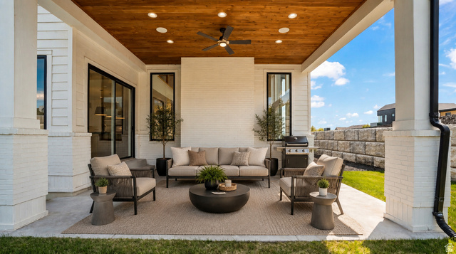 1682 North 1950 W Street, Unit 9 Provo, UT 84604 - Photo 79 of 84 Covered outdoor patio featuring a wood-finish ceiling with recessed lighting and a ceiling fan, white brick columns, and a concrete patio surface