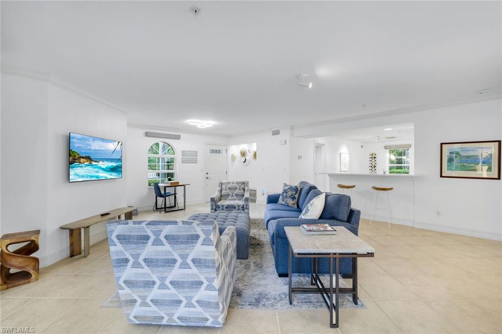 376 3rd Street South, Unit 102 Naples, FL 34102 - Photo 4 of 17 Living room featuring light tile patterned floors and baseboards