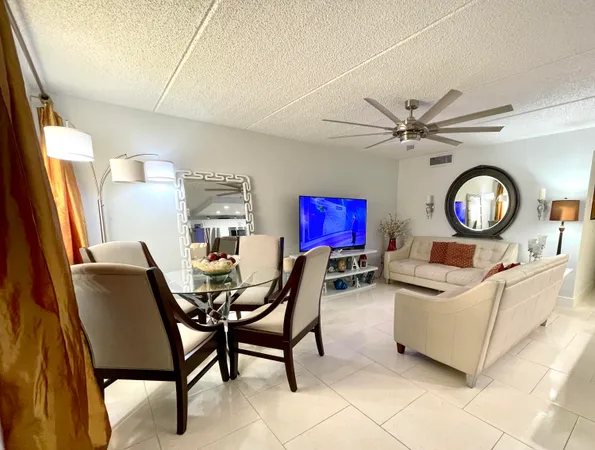 a view of a dining room with furniture and a mirror