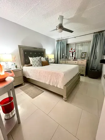 a spacious bedroom with a bed and a chandelier