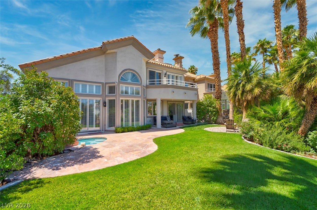 8848 Rainbow Ridge Drive Las Vegas, NV 89117 - Photo 38 of 43 A private backyard oasis awaits, complete with verdant lawn, mature palm trees, and a refreshing spa.