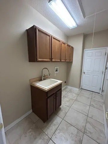 a utility room with a sink dryer and washer