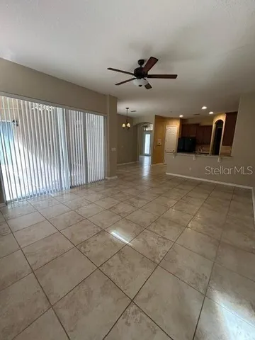a view of a livingroom with a ceiling fan and window