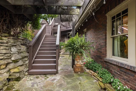 a view of a pathway of house with wooden stairs