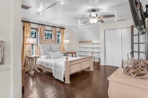 a white bed sitting in a living room next to a window