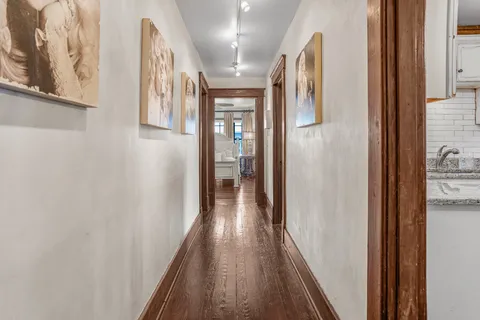 a view of hallway with wooden floor