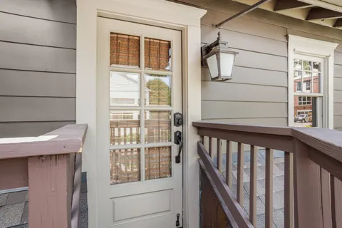 a view of balcony with wooden floor and fence