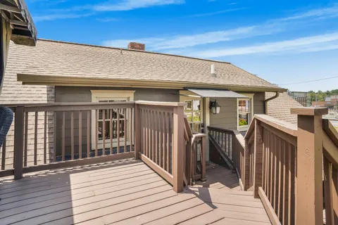 a view of a house with wooden deck
