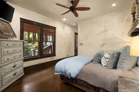 a bedroom with a bed and a flat tv screen