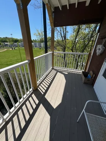 a view of balcony with wooden floor