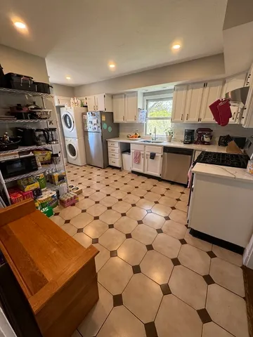 a kitchen with stainless steel appliances kitchen island granite countertop a sink and cabinets
